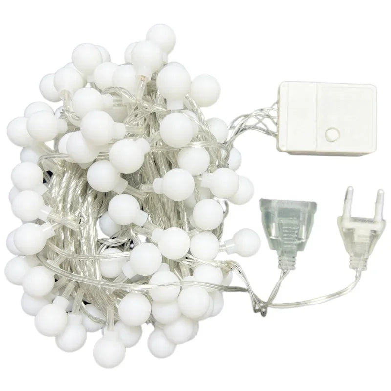String of white LED lights with a power adapter on a white background