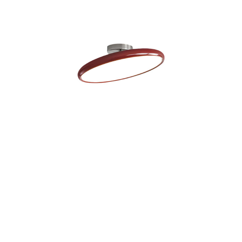 Red ceiling light fixture with branding in a modern living room.