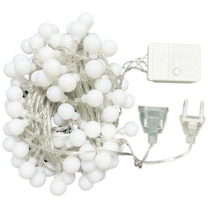 String of white LED lights with a power adapter on a white background