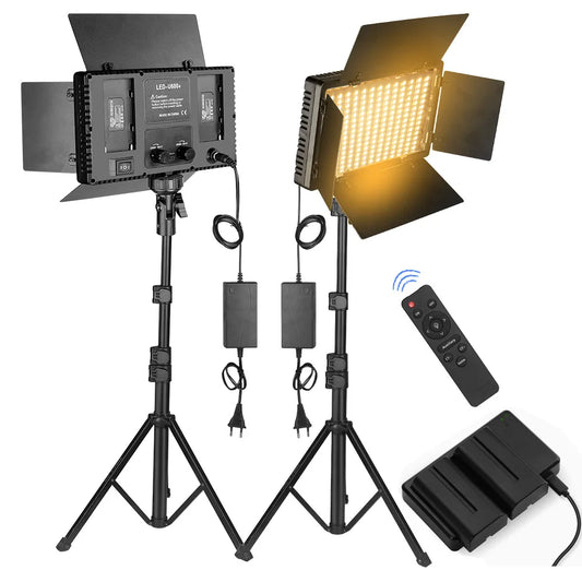 Video studio light kit with two LED panels on stands, power supplies, and remote control on a white background.
