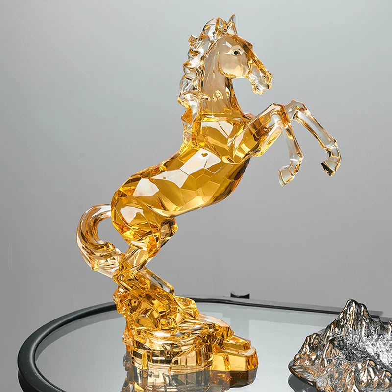 Crystal horse figurine on a reflective surface with a gray background