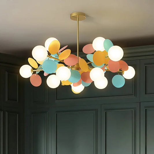 Colorful chandelier hanging in a room with dark paneled walls