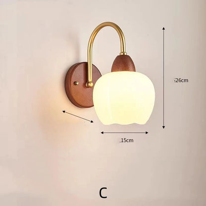 Wall lamp with wooden base and gold arm on a beige background