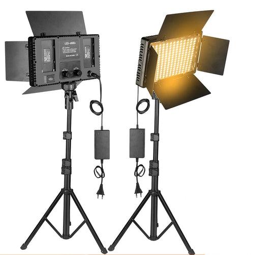 Studio light setup with stands and free battery charger on a white background